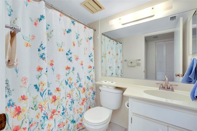 bathroom featuring vanity, toilet, and curtained shower