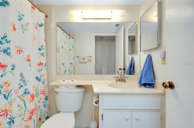 bathroom with vanity, toilet, and a shower with shower curtain