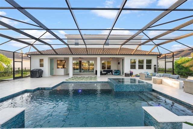 view of swimming pool with an in ground hot tub, a patio, outdoor lounge area, and glass enclosure