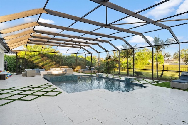 view of pool featuring a patio, an in ground hot tub, pool water feature, an outdoor hangout area, and glass enclosure