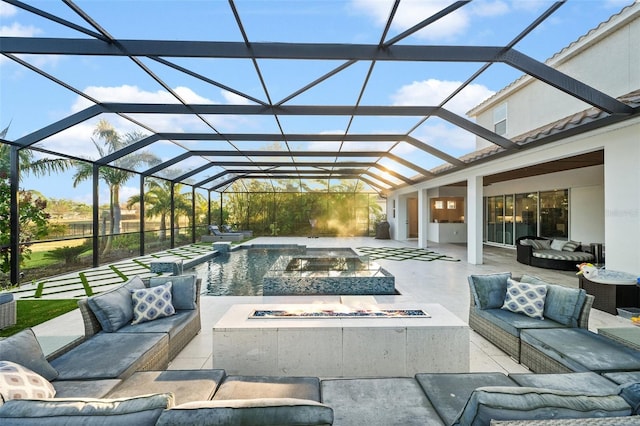 view of swimming pool featuring an in ground hot tub, a lanai, a patio, and an outdoor living space with a fire pit