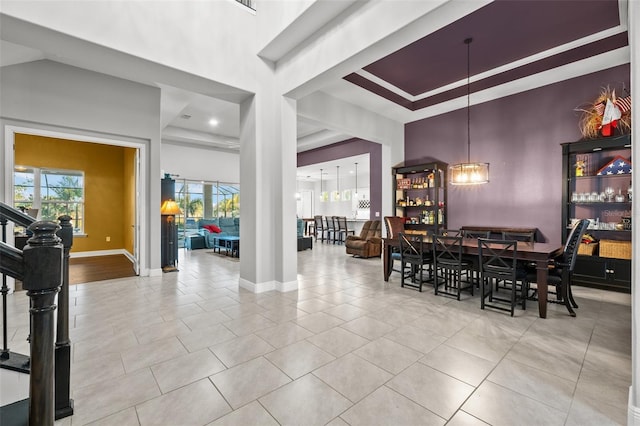 dining room featuring a high ceiling and light tile patterned flooring