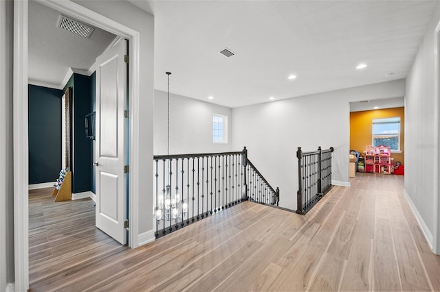 corridor with light hardwood / wood-style floors