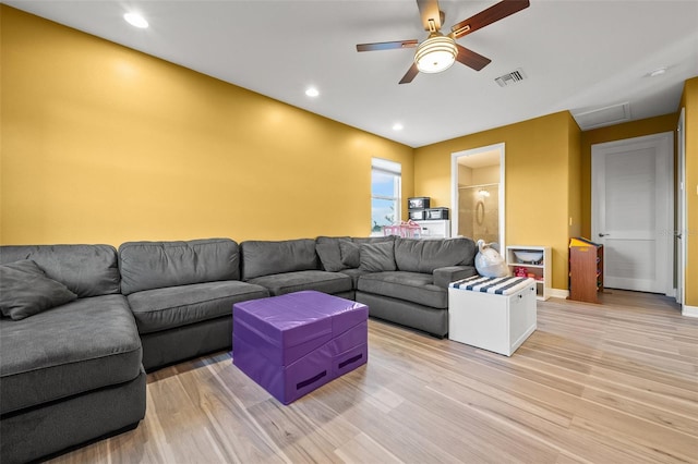 living room featuring ceiling fan and light wood-type flooring