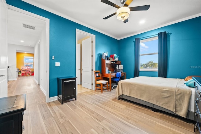 bedroom featuring ornamental molding, ceiling fan, and light hardwood / wood-style floors