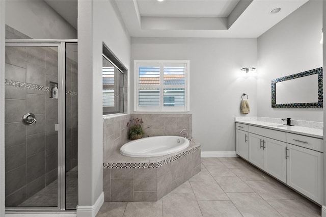 bathroom with vanity, tile patterned floors, plus walk in shower, and a raised ceiling