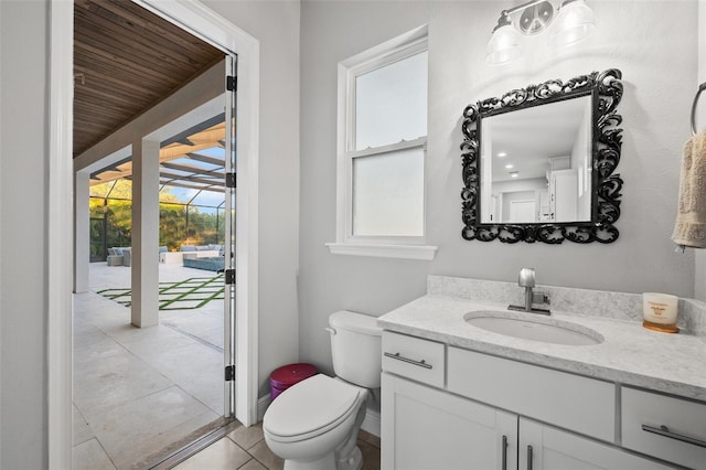 bathroom featuring vanity, tile patterned floors, and toilet