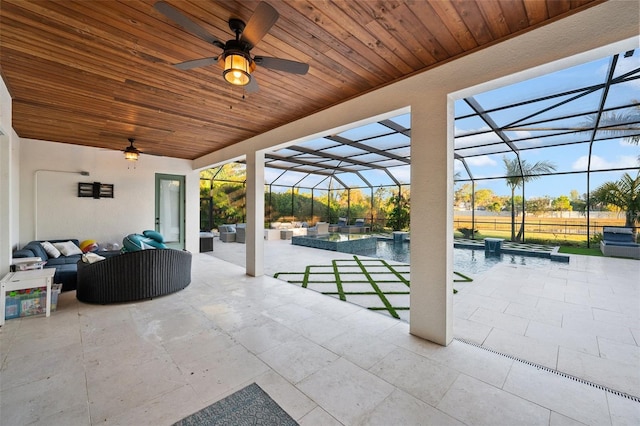 view of patio / terrace with a pool with hot tub, outdoor lounge area, ceiling fan, and glass enclosure