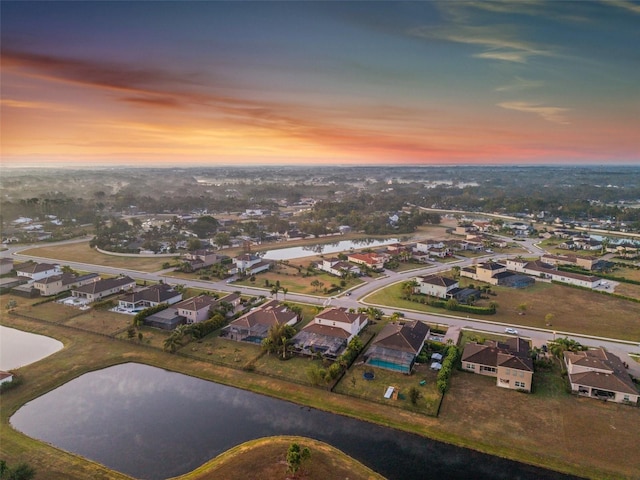 aerial view at dusk with a water view