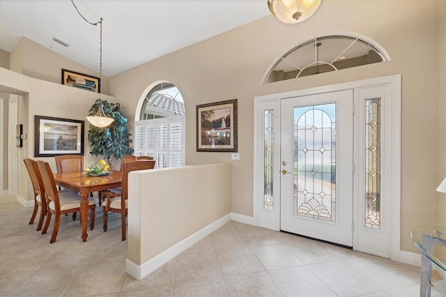 tiled foyer with lofted ceiling