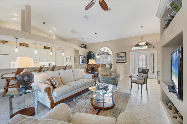 tiled living room with high vaulted ceiling and ceiling fan