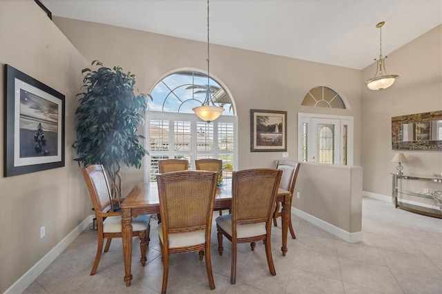 tiled dining room with high vaulted ceiling