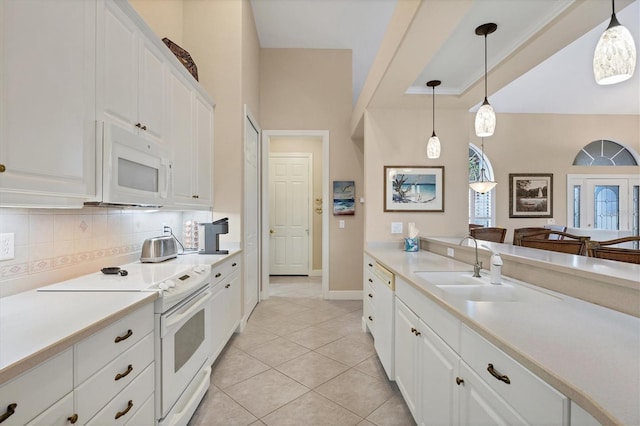 kitchen featuring pendant lighting, white appliances, decorative backsplash, and white cabinets