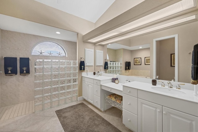 bathroom with tile patterned flooring, vanity, lofted ceiling, and walk in shower