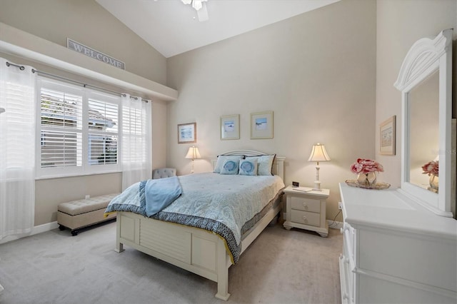 bedroom with vaulted ceiling and light colored carpet