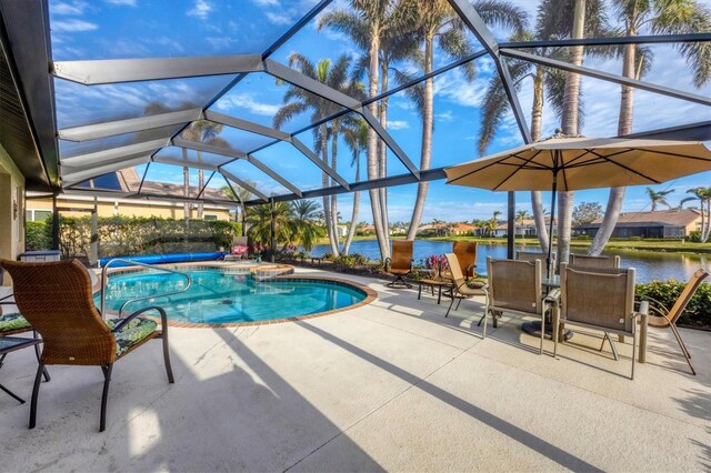 view of pool with a lanai, a patio area, and a water view