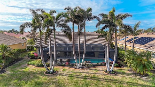 view of swimming pool featuring a lanai and a lawn