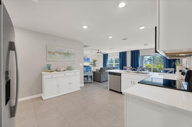 kitchen featuring sink, ceiling fan, white cabinetry, stainless steel appliances, and light tile patterned flooring