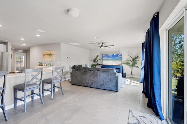 living room featuring light tile patterned flooring and ceiling fan