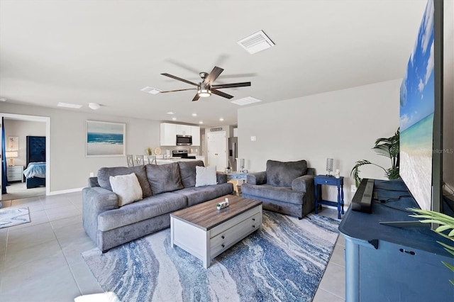 living room with ceiling fan and light tile patterned flooring