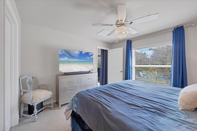 bedroom with light carpet and ceiling fan