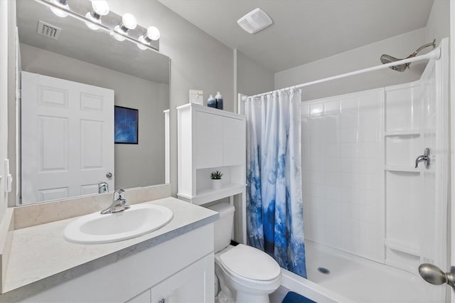 bathroom featuring vanity, curtained shower, and toilet