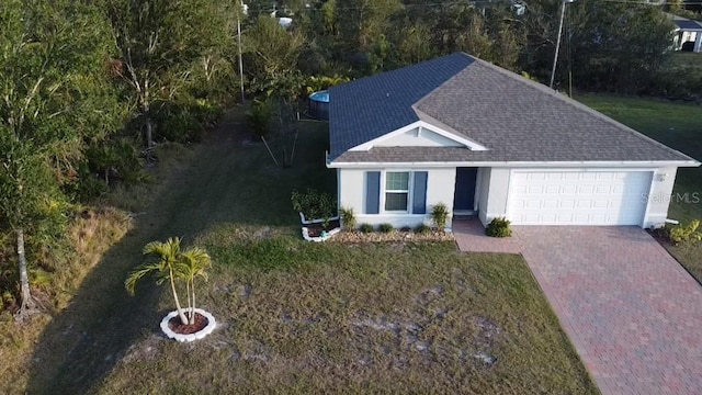 view of front of property featuring a garage and a front lawn