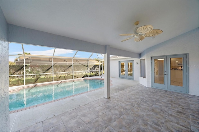 pool featuring glass enclosure, a patio area, french doors, and a ceiling fan