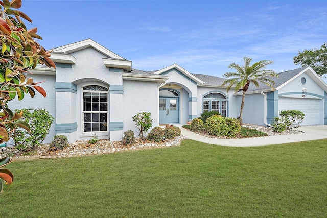 view of front of home with a front lawn, concrete driveway, roof with shingles, stucco siding, and a garage