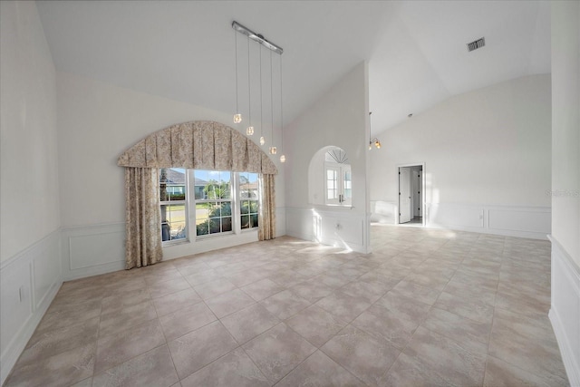 interior space featuring high vaulted ceiling and light tile patterned flooring