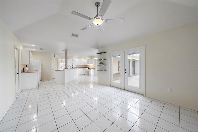 unfurnished living room featuring light tile patterned floors, visible vents, a ceiling fan, and french doors