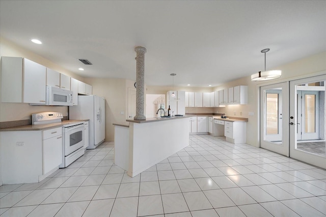 kitchen featuring white appliances, visible vents, light tile patterned flooring, pendant lighting, and white cabinetry