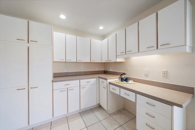 kitchen with white cabinetry and light tile patterned flooring