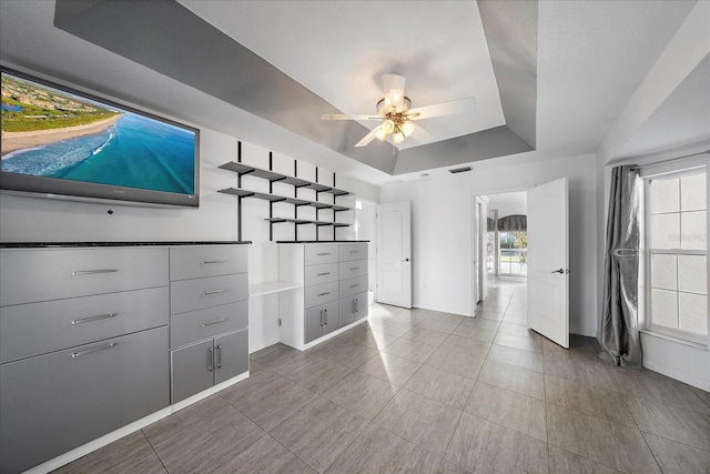 interior space with visible vents and ceiling fan