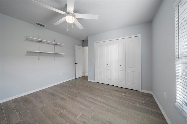 unfurnished bedroom featuring a closet, ceiling fan, and light wood-type flooring