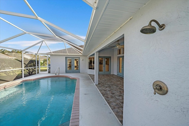 pool with a patio area, french doors, a lanai, and ceiling fan