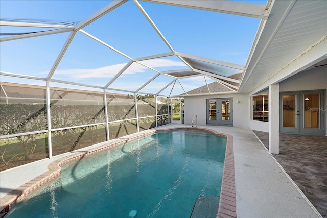 view of swimming pool with a patio, a lanai, and french doors