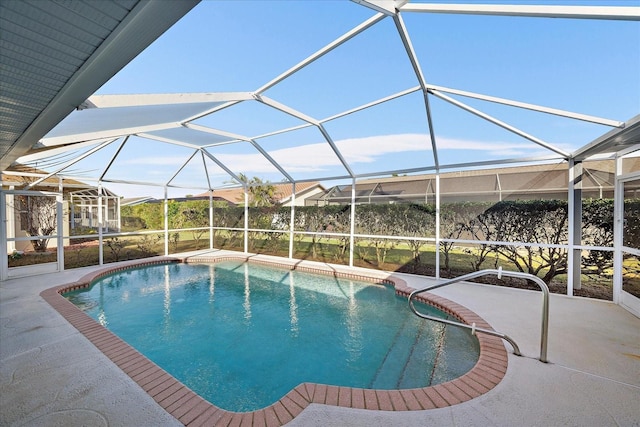 pool featuring glass enclosure and a patio