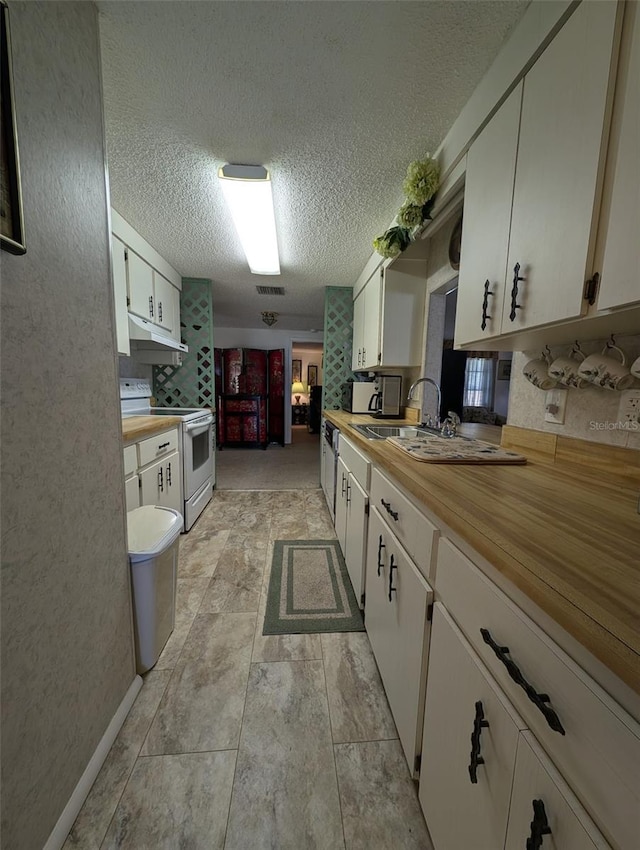 kitchen featuring sink, white cabinetry, a textured ceiling, and electric range