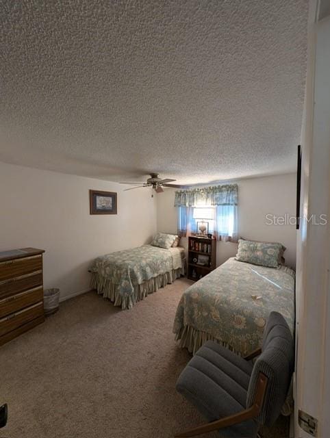 bedroom with carpet, ceiling fan, and a textured ceiling