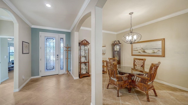 entryway featuring light tile patterned floors, ornamental molding, and a chandelier