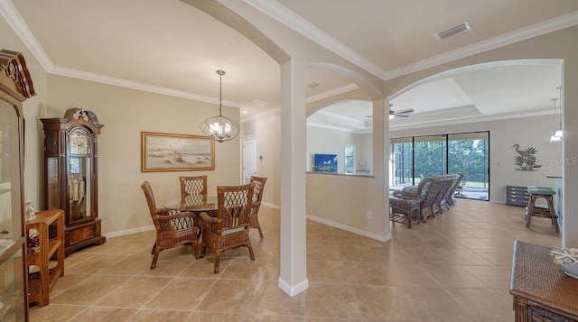 dining area featuring light tile patterned floors, a tray ceiling, and ornamental molding