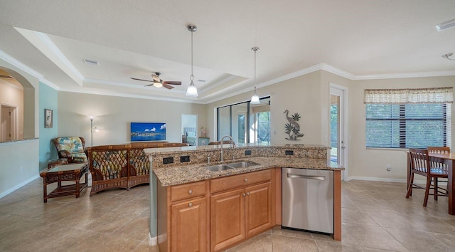 kitchen with sink, decorative light fixtures, a center island with sink, a tray ceiling, and dishwasher