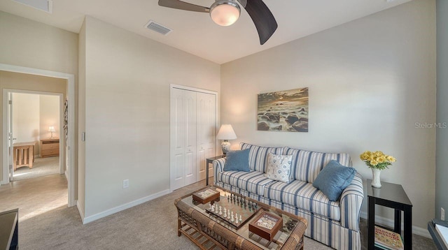 carpeted living room with ceiling fan