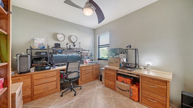 tiled home office featuring ceiling fan