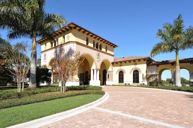 mediterranean / spanish-style home featuring a front lawn