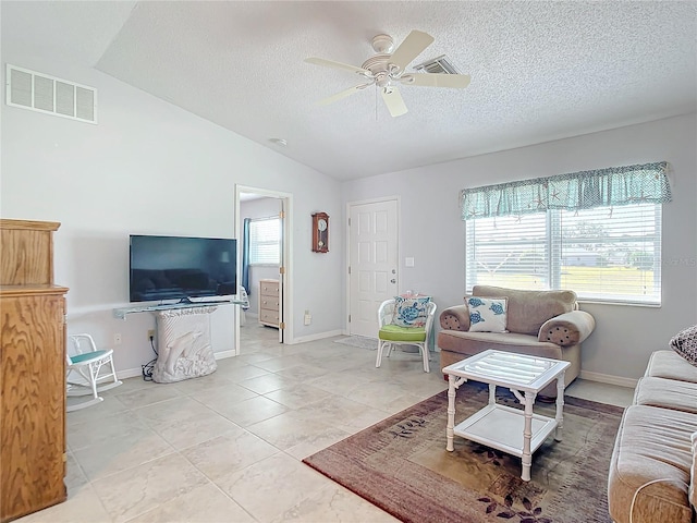 living room with lofted ceiling, light tile patterned floors, a textured ceiling, and ceiling fan