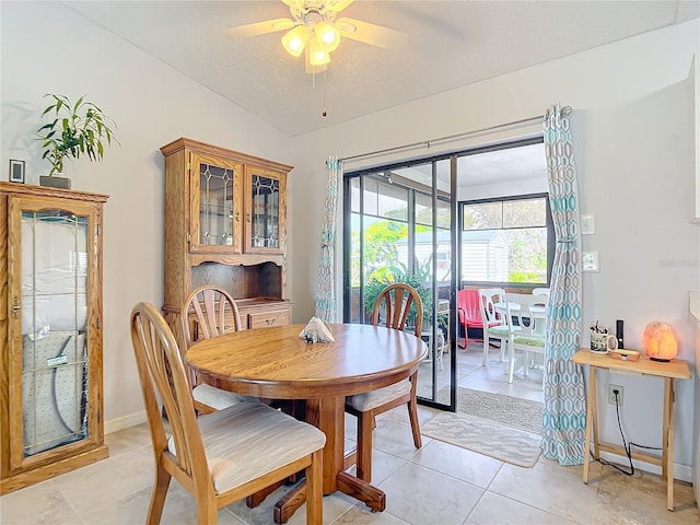 tiled dining room with ceiling fan and a textured ceiling