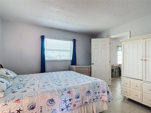 tiled bedroom with a textured ceiling