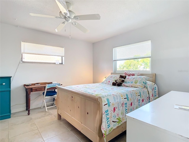 bedroom featuring ceiling fan, a textured ceiling, and light tile patterned flooring